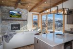 The main living area of O`Brien Penthouse East is framed on both sides by accordion style doors, providing for expansive views of downtown Whitefish & the surrounding mountains.